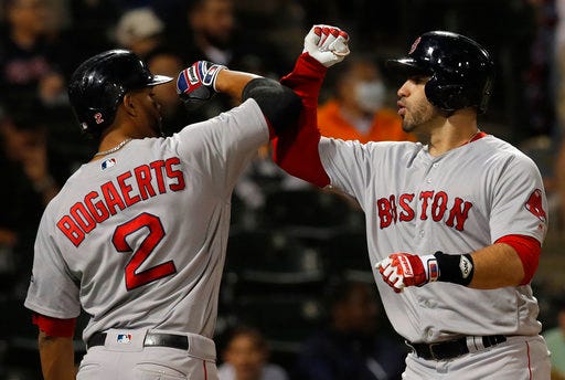 Boston Red Sox's J.D. Martinez, right, celebrates a three-run home run against the Chicago White Sox with teammate Xander Bogaerts during the ninth inning of a baseball game Thursday, Aug. 30, 2018, in Chicago. (AP Photo/Jim Young)
