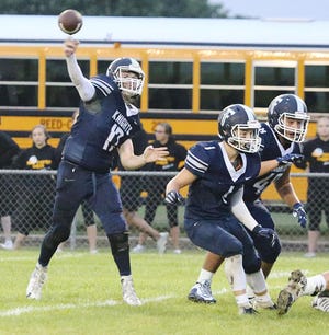 Fieldcrest quarterback Tyler McKay throws a pass with protection from Keegan Robbins (1) and Trenton Castrejon during last week’s season-opening victory over Reed-Custer.
