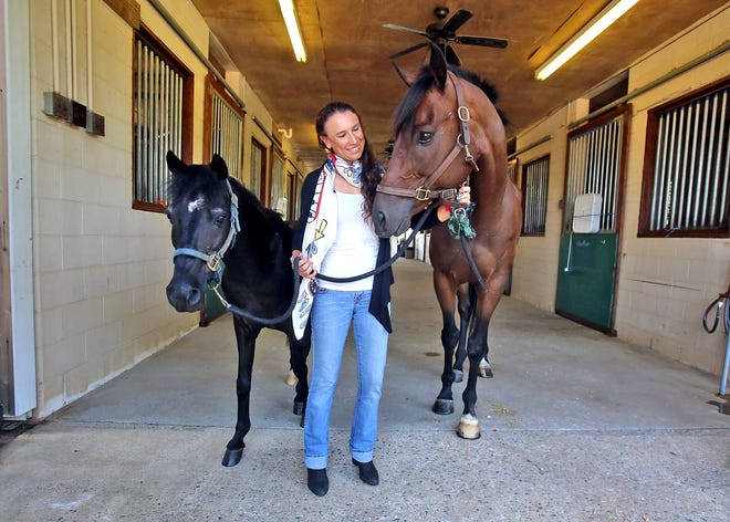 Daniela Moguel spends time with horses at Charlie Horse Farm in Shelby on Monday. Moguel will represent her country of Mexico in the eventing discipline aboard horse Cecelia at the World Equestrian Games in September. [Brittany Randolph/The Star]