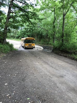 An Alma School District bus crosses a flooded low-water bridge over East Cedar Creek in this undated photo. [COURTESY OF CRAWFORD COUNTY EMERGENCY MANAGEMENT]