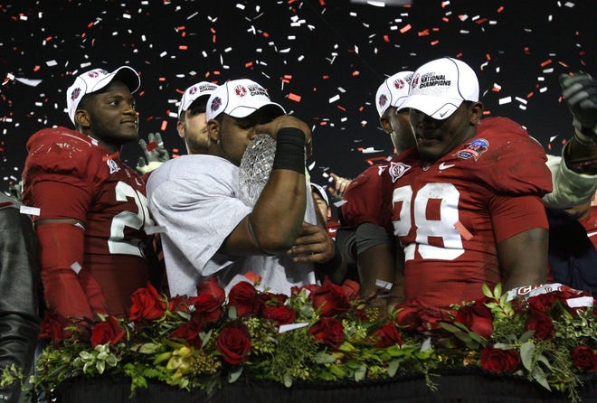 Alabama linebacker Rolando McClain (25) running back Mark Ingram (22) and defensive back Javier Arenas (28) celebrate following the Crimson Tide's 37-21 victory over Texas at the Rose Bowl in Pasadena, California, in the BCS national title game. The win capped a perfect 14-0 season. Alabama has won five national titles under Nick Saban, but has just one undefeated season. [File photo]