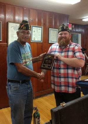 Past Commander Eric Cantu, left, was presented a plaque and pin for his 10 years serving as Post Commander of the Lenoir VFW Post 2771. Presenting the plaque is the current Post Commander Michael Whitley. [Contributed photo]