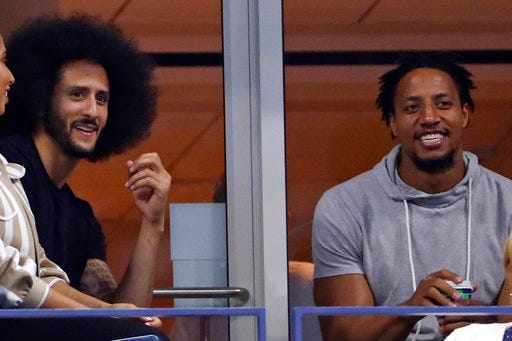 Colin Kaepernick, left and Eric Reid look watch Serena Williams play Venus Williams during the third round of the U.S. Open tennis tournament Friday, Aug. 31, 2018, in New York. (AP Photo/Adam Hunger)
