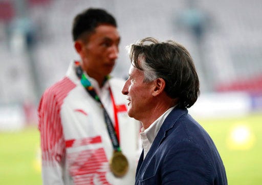 In this Saturday Aug. 25, 2018 photo, President of the International Association of Athletics Federations (IAAF) Sebastian Coe waits at the medal ceremony for the men's marathon during the athletics competition at the 18th Asian Games in Jakarta, Indonesia. Coe says China and Japan are the two most improved countries in athletics over the last six or seven years.(AP Photo/Bernat Armangue)