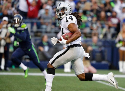 Oakland Raiders wide receiver Keon Hatcher (14) runs for a touchdown against the Seattle Seahawks after making a catch during the first half of an NFL football preseason game, Thursday, Aug. 30, 2018, in Seattle. (AP Photo/Elaine Thompson)