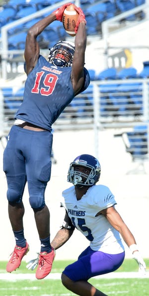 Malone's Ashton Dulin jumps for the ball during a 2017 game played against Kentucky Wesleyan College held at Tom Benson Hall of Fame Stadium. (CantonRep.com / Michael Balash)