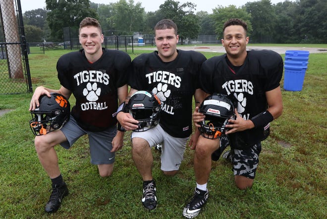 Maynard football senior co-captains Tommy Smith, 17, Timmy Lawton, 17 and Josh Dornelas, 18, pose for a shot during practice Wednesday, Aug. 22, 2018. [Wicked Local Staff Photo/Ann Ringwood]