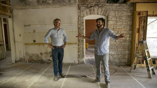 Waller Creek Conservancy Director Peter Mullan, left, and contractor Antonio Madrid look inside the Hardeman House, one of three buildings at Symphony Square that will become the headquarters of the conservancy. JAY JANNER / AMERICAN-STATESMAN