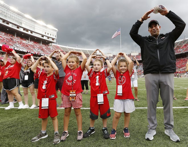 Ohio State Buckeyes head coach Ryan Day sings "Carmen Ohio" with his daughters and nephews following the NCAA football game against the Oregon State Beavers at Ohio Stadium in Columbus on Sept. 1, 2018. Ohio State won 77-31. [Adam Cairns / Dispatch]