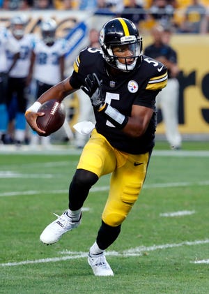 Pittsburgh Steelers quarterback Joshua Dobbs runs with the ball during the first half of a preseason NFL football game against the Carolina Panthers in Pittsburgh, Thursday, Aug. 30, 2018. (AP Photo/Keith Srakocic)