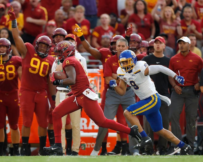 Iowa State wide receiver Deshaunte Jones (left) breaks away from South Dakota State cornerback Jordan Brown to score a touchdown in Saturday's game. The game was eventually cancelled because of thunderstorms. [Matthew Putney/The Associated Press]