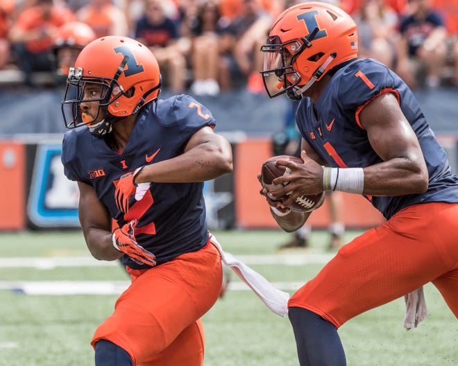 Illinois quarterback AJ Bush Jr., right, fakes a hand off to running back Reggie Corbin, left, in the first quarter of an NCAA college football against Kent State in Champaign, Ill., Saturday, Sept. 1, 2018. (AP Photo/Holly Hart)