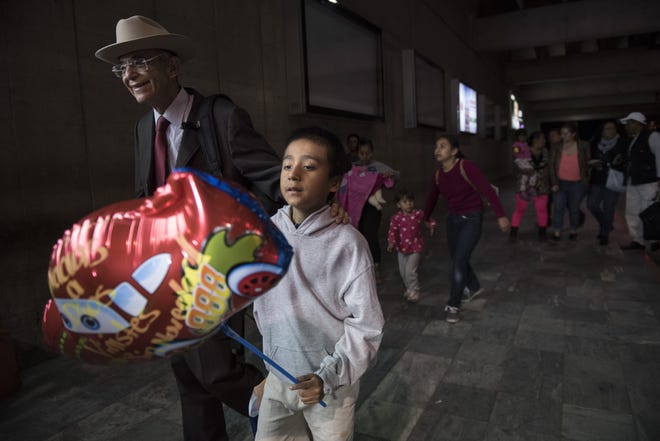 Anthony David Tovar Ortiz, center, is accompanied by attorney Ricardo de Anda after arriving to La Aurora airport in Guatemala City, Tuesday, Aug. 14, 2018. The 8-year-old stayed in a shelter for migrant children in Houston after his mother Elsa Ortiz Enriquez was deported in June 2018 under President Donald Trump administration's zero tolerance policy. (AP Photo/Oliver de Ros)