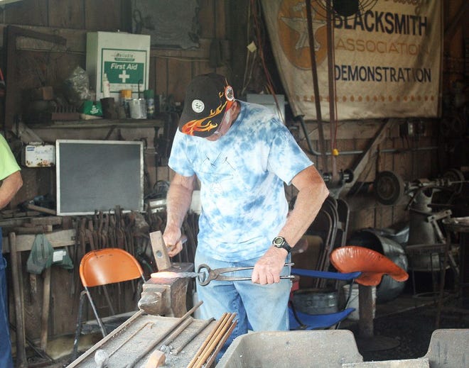 Delbert Myers, a member of the Illinois Valley Blacksmith Association, works a piece of metal at the Threshermen's Reunion Friday morning.