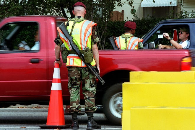 Fort Bragg soldiers check identifications of drivers at the Access Control Point on Butner Road on Sept. 10, 2002. [Steve Hebert/The Fayetteville Observer]