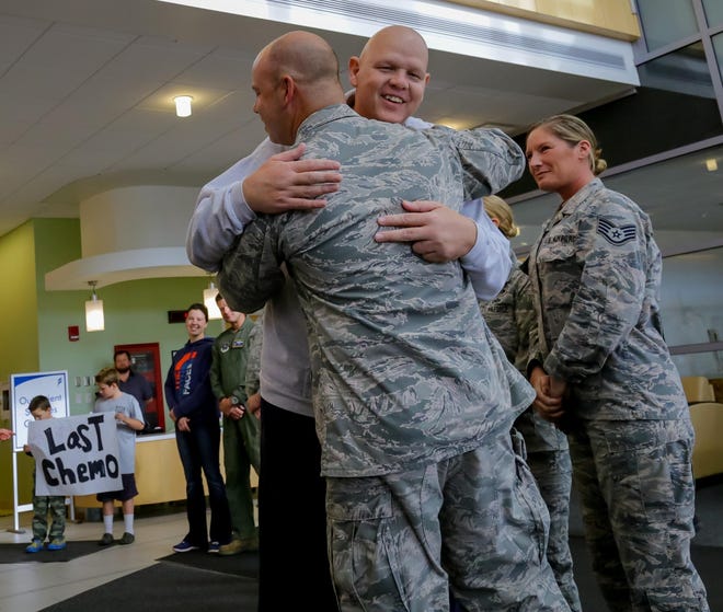 In this September 2016 photo, MSgt. Michael Ploof of Rochester gets a hug from William Davis of the 157th Air Refueling Wing at the Pease Air National Guard Base. Ploof, 55, now retired from the guard, was diagnosed with Non-Hodgkinís lymphoma in February 2016. [Shawn St. Hiliare/Fosters.com, file]