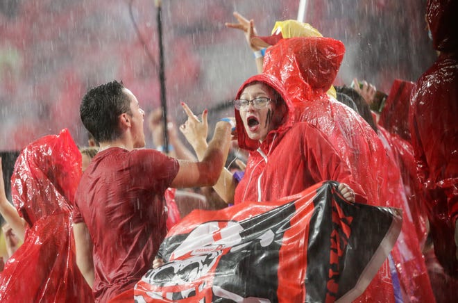 Fans at Memorial Stadium dance to music during a lightning and rain delay in the first half of an NCAA college football game between Nebraska and Akron in Lincoln, Neb., Saturday, Sept. 1, 2018. (AP Photo/Nati Harnik)