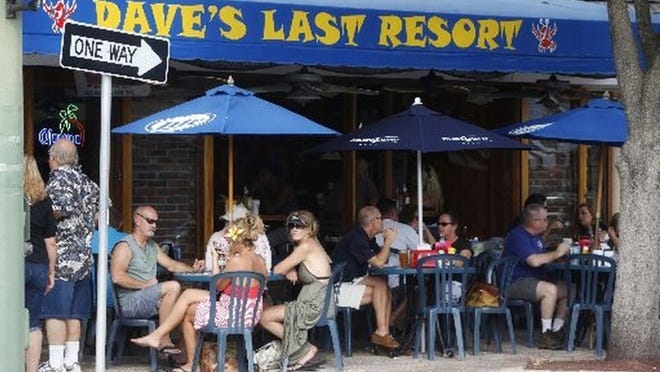 Visitors to downtown Lake Worth sit on the sidewalk at Dave’s Last Resort in 2011. (Bruce R. Bennett/The Palm Beach Post)