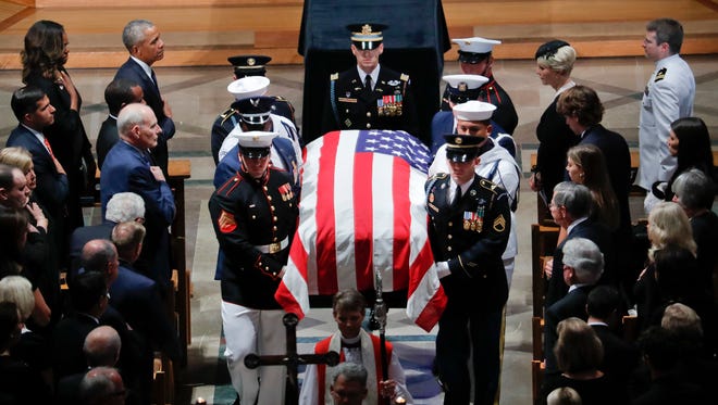 The family of Sen. John McCain, R-Ariz., follows as his casket is carried during the recessional at the end of a memorial service at Washington National Cathedral in Washington on Saturday. [Pablo Martinez Monsivais/The Associated Press]