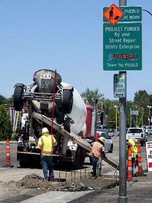 Crews work on Santa Fe Avenue near 10th Street earlier this year as part of a street-improvement plan approved, and funded, by taxpayers. [CHIEFTAIN PHOTO/FILE]