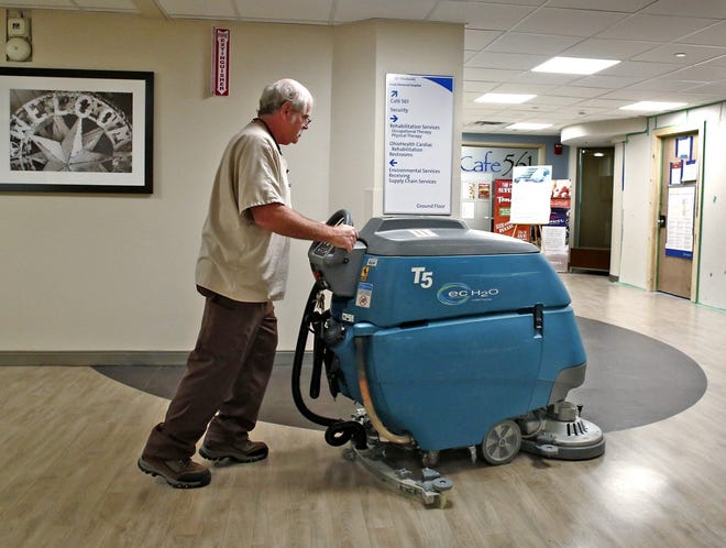 Donnie Miller, who works in environmental services for OhioHealth Grady Memorial Hospital in Delaware, cleans a floor on Tuesday. Miller is known around the hospital for his thorough work and friendly personality. [Fred Squillante/Dispatch]