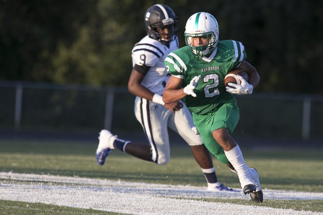 Ashbrook's Carlos Brooks picks up a big gain against East Mecklenburg on Aug. 24. [David Luoto/Special to The Gazette]