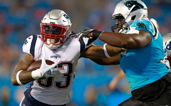New England Patriots' Jeremy Hill (33) is tackled by Carolina Panthers' Sterling Bailey (79) during the second half of a preseason NFL football game in Charlotte, N.C., Friday, Aug. 24, 2018. (AP Photo/Jason E. Miczek)