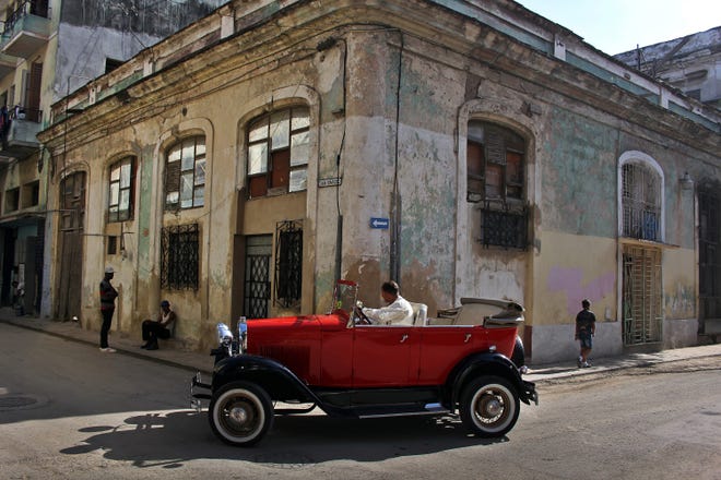 A car manufactured almost a century ago drives on a street in Havana, Cuba. [ALEJANDRO ERNESTO/ZUMA PRESS/TNS]