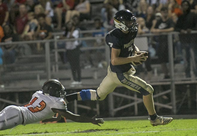 Eustis' Glen Register (7) makes a carry against Leesburg on Friday in Eustis. Register replaced injured quarterback Tanner Romano and sparked the Panthers to the win. [PAUL RYAN / CORRESPONDENT]