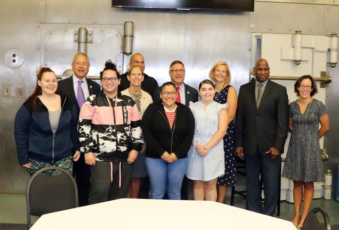 At a recent ceremony, People Incorporated’s Urban Youth Collaborative program graduated 12 interns who worked during the spring and summer in various services that the agency offers. [Submitted photo]