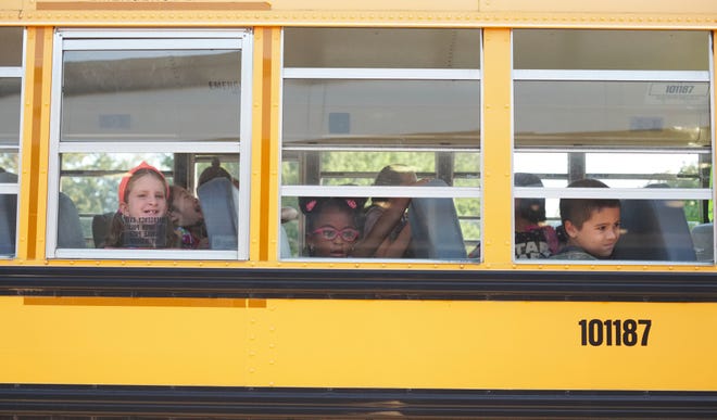 Melville Elementary School students arrive for the first day of school in Portsmouth on Wednesday, Aug. 29. [PETER SILVIA PHOTO]