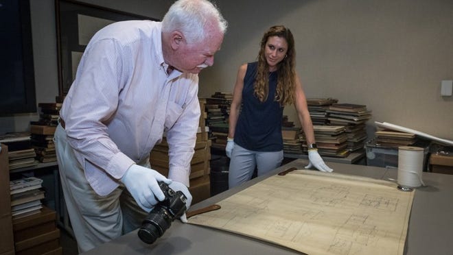 Art appraisers Robert Hittel and Brittany Hyde examine a drawing by the late society architect John L. Volk of a residence designed for attorney Herbert Pulitzer, dated Dec. 11, 1940, inside the Preservation Foundation of Palm Beach meeting room Wednesday, August 22, 2018. Volk’s son, the late John K. Volk, has donated more than 28,000 drawings, 4,000 photographs, 100 boxes archival materials and 300 historic and local books to the foundation. Labell said the work to appraise, inventory and cataglog the Volk collection will span over the course of the next four months. (Damon Higgins / Daily News)