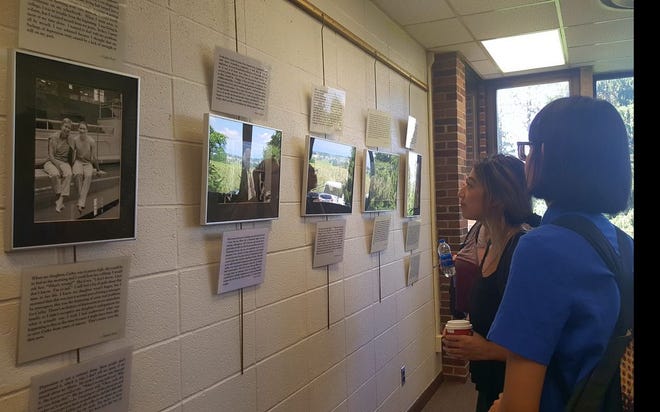 Rozz Monnin and Corissa Nguyen, Penn State Mont Alto freshmen, look at the "Nothing to Hide" photo-text exhibit Tuesday on the campus.