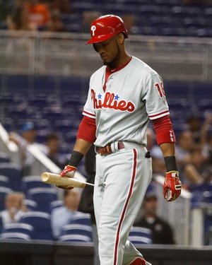 The Phillies' Pedro Florimon walks off the field after striking out in the ninth inning of Wednesday's game. [Brynn Anderson / Associated Press]