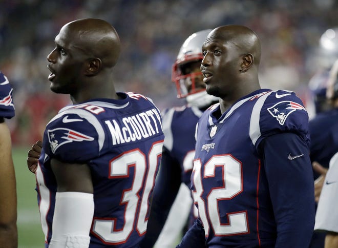 Patriots identical twins, defensive backs Jason McCourty (30) and Devin McCourty (32) watch from the sideline during preseason action last month. The pats open the 2018 season Sunday at home against the Texans. [AP photo]