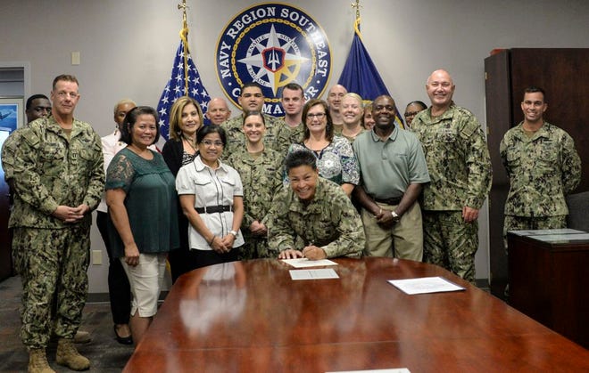 Photo by MC1 Brian G. Reynolds
Rear Adm. Bette Bolivar, commander, Navy Region Southeast, signs a proclamation declaring September as Suicide Awareness Month in the Southeast Region. Since 2007, the Navy has used the acronym ACT (act, care, treat) to encourage Sailors to help save a life.
