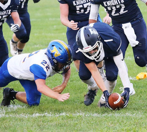 Fieldcrest’s Keegan Robbins scoops up the football during last week’s Heart of Illinois Conference Large Division contest against Tri-Valley. The Knights took one on the chin and will look to rebound this week in a nonconference matchup with Tremont on the Turks’ home field.