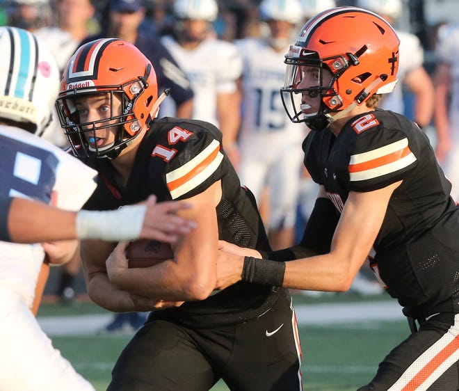 Hoover's Adam Griguolo (14) takes a handoff from Connor Ashby (2) during last week's win against Louisville. (CantonRep.com / Scott Heckel)