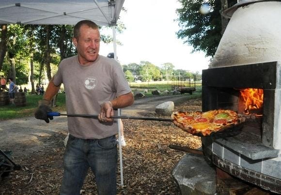 Kevin O'Dwyer serves up pizza at Langwater Farm in Easton on Friday, Aug. 31, 2018. (Marc Vasconcellos / The Enterprise)