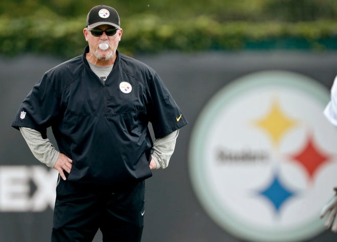 In this photo from Sept. 5, 2018, Pittsburgh Steelers offensive coordinator Randi Fichtner blows a bubble-gum bubble as he watches the quarterbacks go through drills during an NFL football practice in Pittsburgh. Fichtner is ready to be second-guessed. Good thing, because it's coming. The teams new offensive coordinator is ready to put his own unique imprint on one of the league's most potent attacks, with or without running back Le'Veon Bell. (AP Photo/Keith Srakocic)