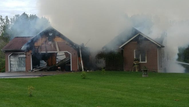 Crews battle an active house fire in the 4600 block of 46th Street in Overisel Township. [Erin Dietzer/Sentinel staff]