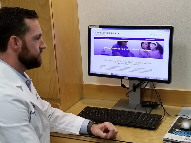 Dr. Ryan Owen shows a fertility website while talking about advances in preserving fertility before cancer treatment begins for children. [Karen Michael/A-J Media]