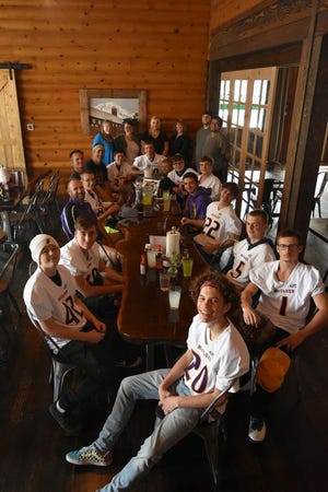 The 2018 McCloud High School football team seated at the Axe & Rose Public House with owner Cindy Rosmann and staff members Marianne Endoso, Trina Dunn, Anne Jenkins, Lonnie Henson,and Bobby Poindexter (standing) during a free cheeseburgers and fries dinner the night before their first game. Axe & Rose Public House is a new restaurant in McCloud and a supporter of the Loggers.