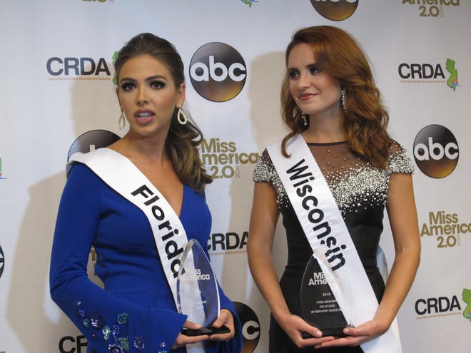 Miss Florida, Taylor Tyson, left, and Miss Wisconsin, Tianna Vanderhei, talk to the media after the first night of preliminary competition at the Miss America competition in Atlantic City, N.J., Wednesday, Sept. 5, 2018. Tyson won the talent competition and Vanderhei won the onstage interview competition. (AP Photo/Wayne Parry)