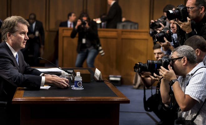 With photojournalists documenting his arrival to the hearing room, Supreme Court nominee Brett Kavanaugh listens during his confirmation hearing on Capitol Hill on Thursday. [The Washington Post / Melina Mara]