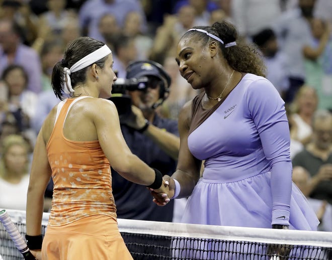 Serena Williams, right, shakes hands with Anastasija Sevastova after their semifinal match Thursday night. Williams dropped the first two games before winning 12 of the last 13. [The Associated Press]