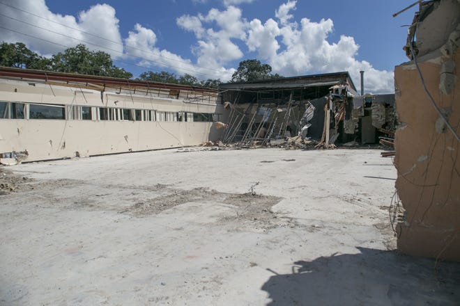 The old community center demolition is underway at Venetian Gardens on Friday. [Cindy Sharp/Correspondent]