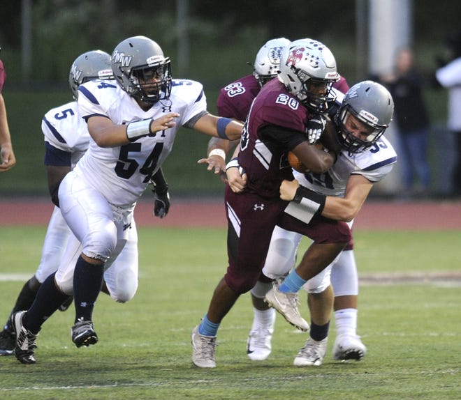 Stroudsburg's Brandon Burrell, center, is brought down by Pocono Mountain West's Colin Kennelly, right, on Friday night. The Mounties came out on top 37-17. [KEITH R. STEVENSON/POCONO RECORD]