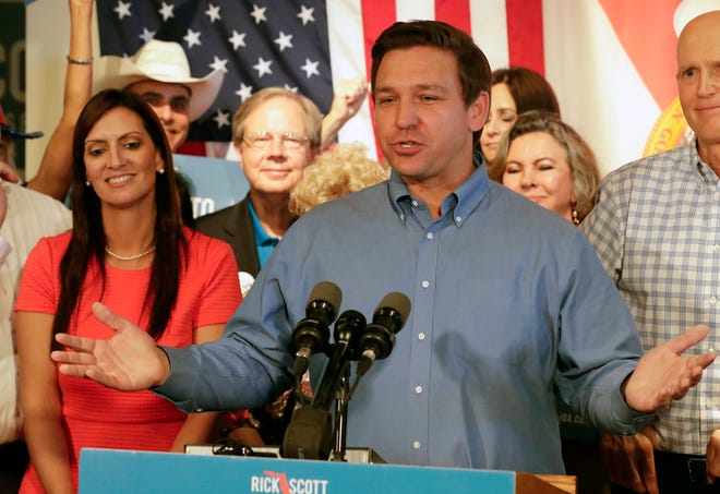 Republican candidate for Governor Ron DeSantis speaks to supporters as his lieutenant governor candidate state Rep. Jeanette Nunez listens during a rally Thursday in Orlando. [John Raoux/The Associated Press]