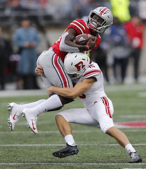 Ohio State running back Demario McCall gets stopped by Rutgers place kicker Justin Davidovicz on a kickoff return during the third quarter. [Jonathan Quilter/Dispatch]